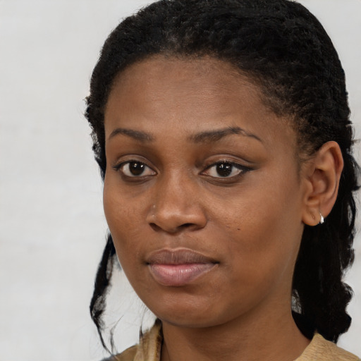 Joyful black young-adult female with short  brown hair and brown eyes