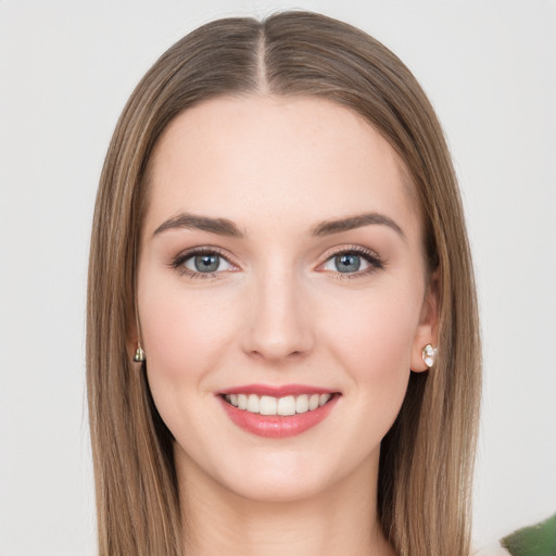 Joyful white young-adult female with long  brown hair and green eyes