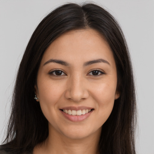 Joyful latino young-adult female with long  brown hair and brown eyes