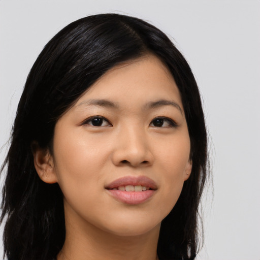 Joyful asian young-adult female with long  black hair and brown eyes