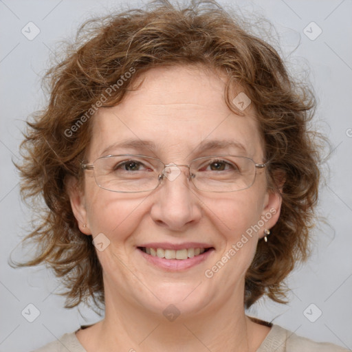 Joyful white adult female with medium  brown hair and blue eyes