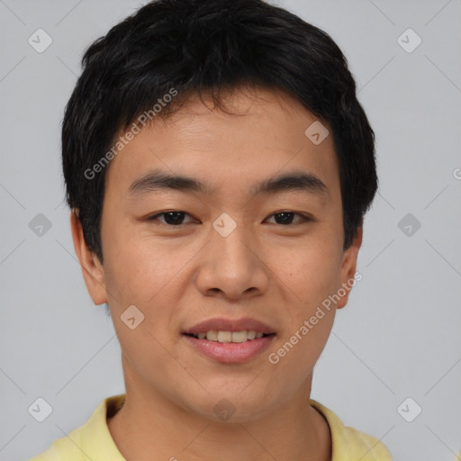 Joyful asian young-adult male with short  brown hair and brown eyes