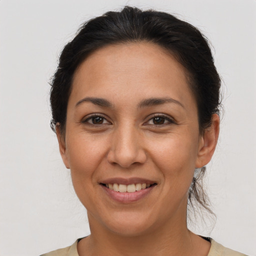 Joyful latino adult female with short  brown hair and brown eyes