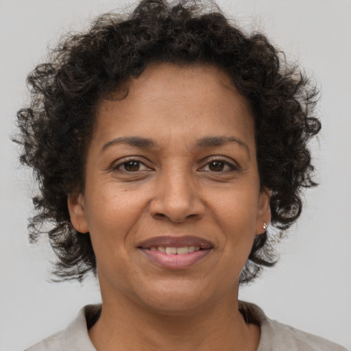 Joyful black adult female with short  brown hair and brown eyes