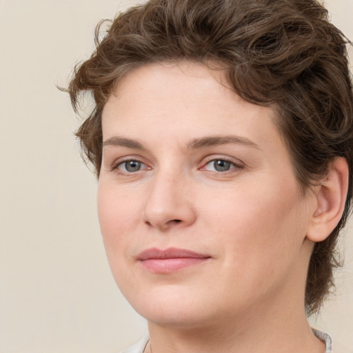 Joyful white young-adult female with medium  brown hair and green eyes