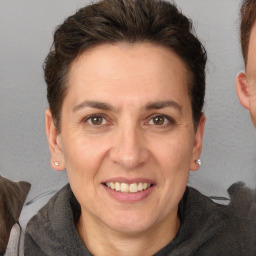 Joyful white adult female with short  brown hair and brown eyes