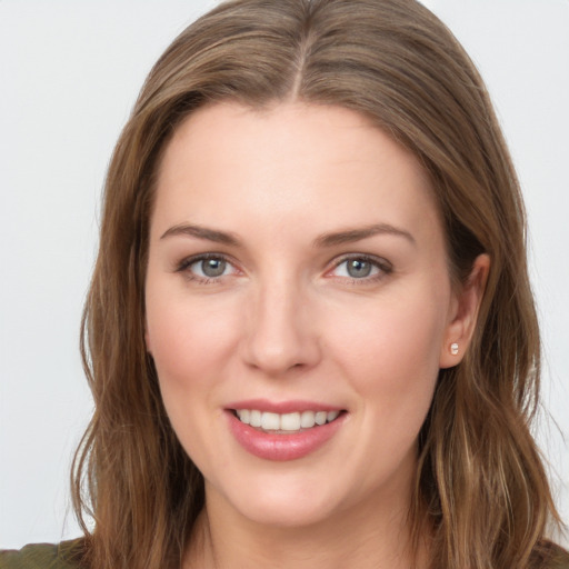 Joyful white young-adult female with long  brown hair and grey eyes