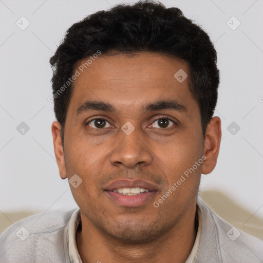 Joyful latino young-adult male with short  black hair and brown eyes