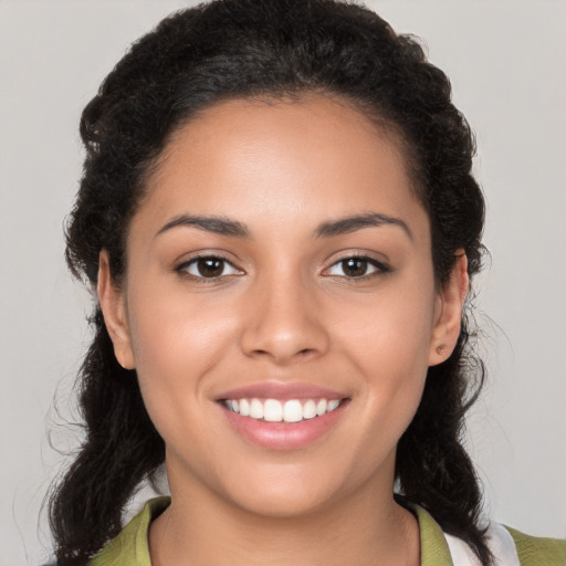 Joyful latino young-adult female with medium  brown hair and brown eyes