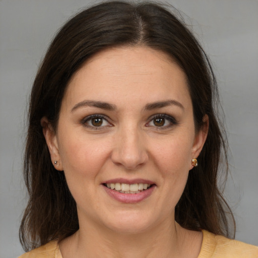 Joyful white young-adult female with medium  brown hair and brown eyes