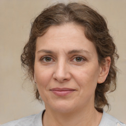 Joyful white adult female with medium  brown hair and brown eyes