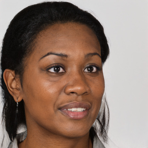 Joyful black young-adult female with medium  brown hair and brown eyes