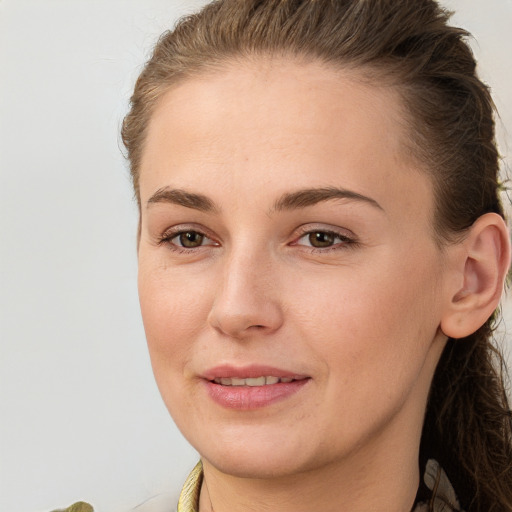 Joyful white young-adult female with long  brown hair and brown eyes