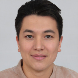 Joyful asian young-adult male with short  black hair and brown eyes