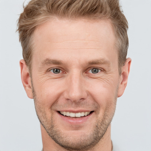 Joyful white adult male with short  brown hair and grey eyes