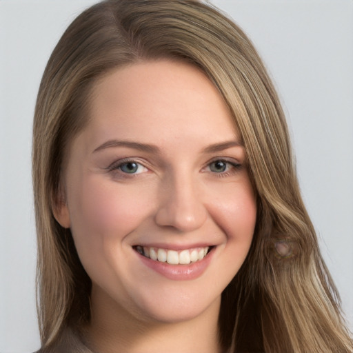 Joyful white young-adult female with long  brown hair and grey eyes