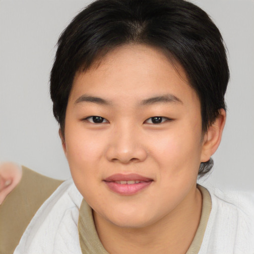 Joyful asian young-adult female with short  brown hair and brown eyes