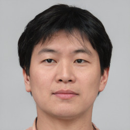 Neutral asian young-adult male with short  brown hair and brown eyes