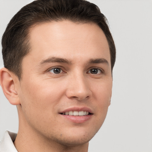 Joyful white young-adult male with short  brown hair and brown eyes