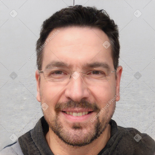 Joyful white adult male with short  brown hair and brown eyes