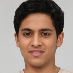 Joyful latino young-adult male with short  brown hair and brown eyes