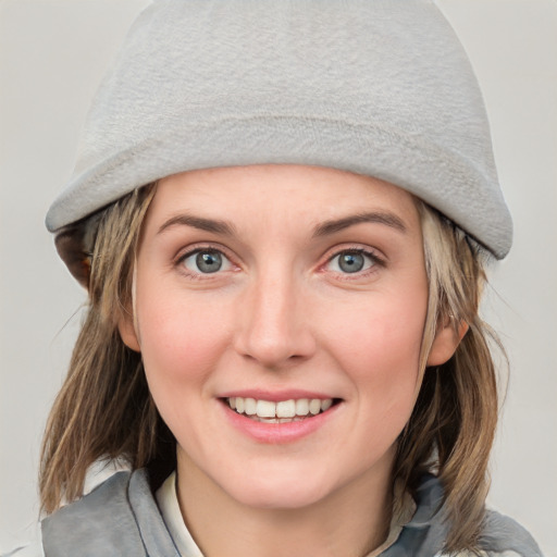 Joyful white young-adult female with medium  brown hair and blue eyes