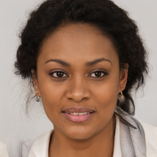 Joyful black young-adult female with medium  brown hair and brown eyes