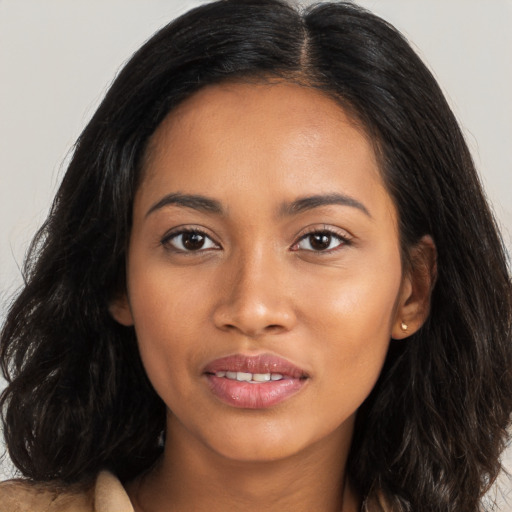 Joyful latino young-adult female with long  brown hair and brown eyes