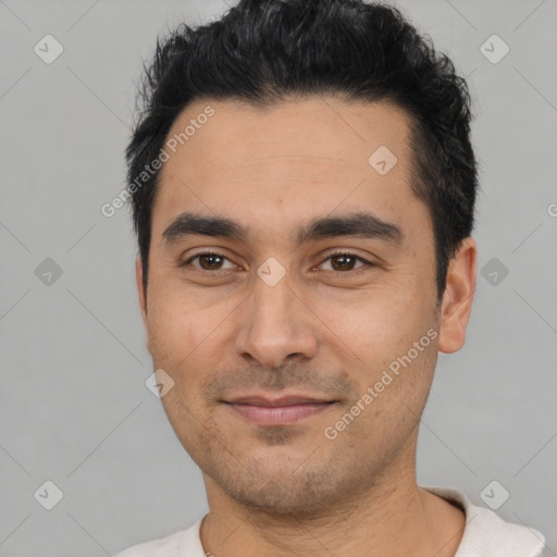 Joyful latino young-adult male with short  black hair and brown eyes