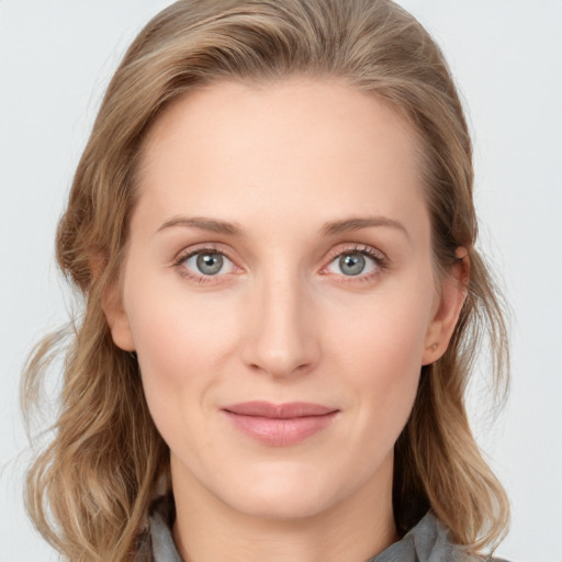 Joyful white young-adult female with medium  brown hair and blue eyes