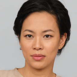 Neutral asian young-adult female with medium  brown hair and brown eyes