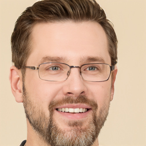 Joyful white adult male with short  brown hair and grey eyes