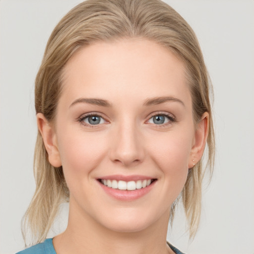 Joyful white young-adult female with medium  brown hair and blue eyes