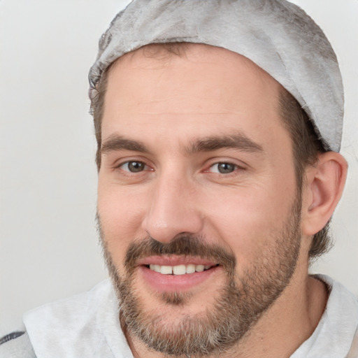 Joyful white adult male with short  black hair and brown eyes