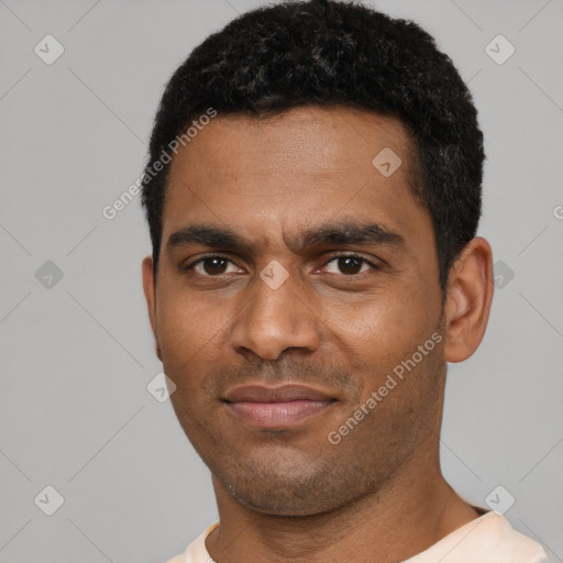 Joyful black young-adult male with short  black hair and brown eyes