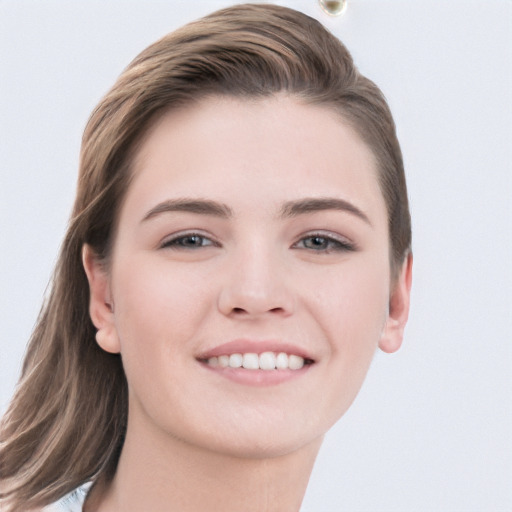 Joyful white young-adult female with long  brown hair and grey eyes