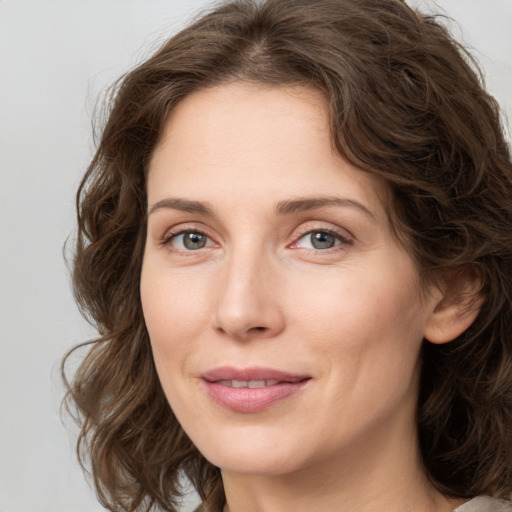 Joyful white young-adult female with medium  brown hair and green eyes