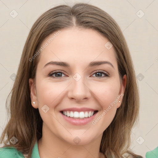 Joyful white young-adult female with medium  brown hair and green eyes