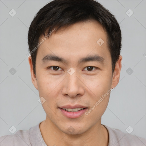 Joyful asian young-adult male with short  brown hair and brown eyes