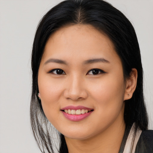 Joyful asian young-adult female with long  brown hair and brown eyes