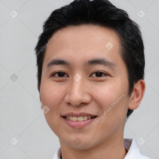 Joyful asian young-adult male with short  brown hair and brown eyes