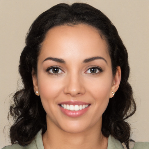 Joyful latino young-adult female with long  black hair and brown eyes