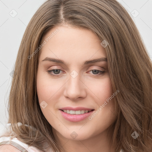 Joyful white young-adult female with long  brown hair and green eyes