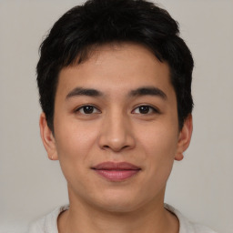 Joyful asian young-adult male with short  brown hair and brown eyes