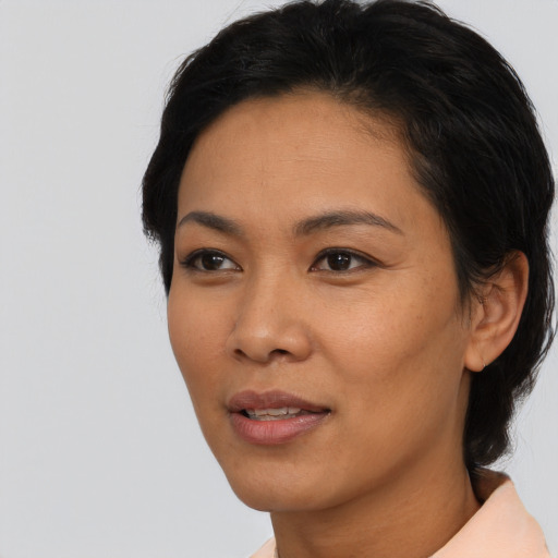 Joyful asian young-adult female with short  black hair and brown eyes