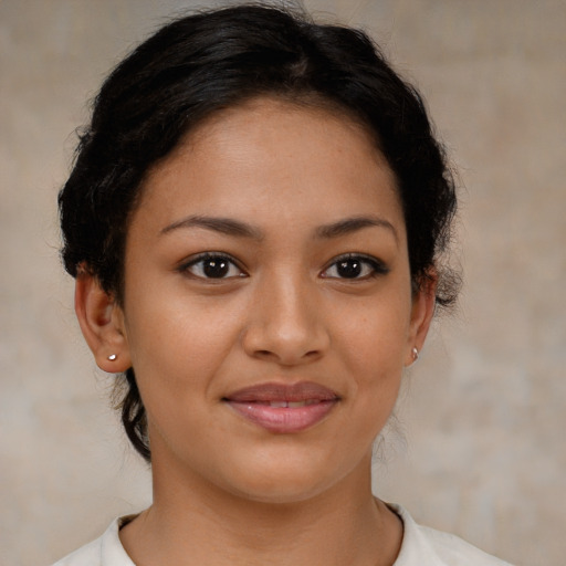 Joyful latino young-adult female with short  brown hair and brown eyes