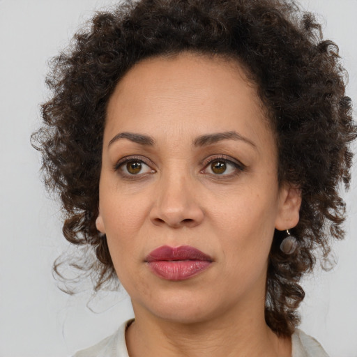 Joyful black adult female with medium  brown hair and brown eyes