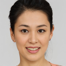 Joyful asian young-adult female with short  brown hair and brown eyes