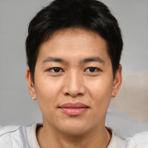 Joyful asian young-adult male with short  brown hair and brown eyes