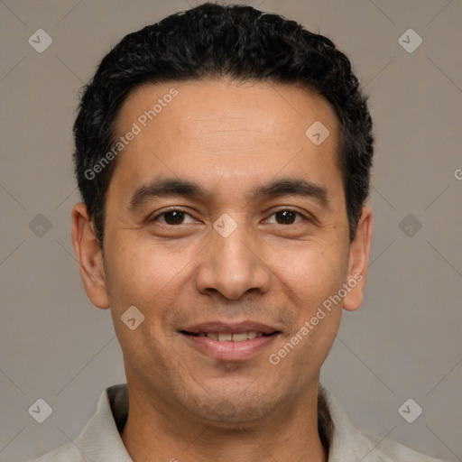 Joyful white adult male with short  black hair and brown eyes